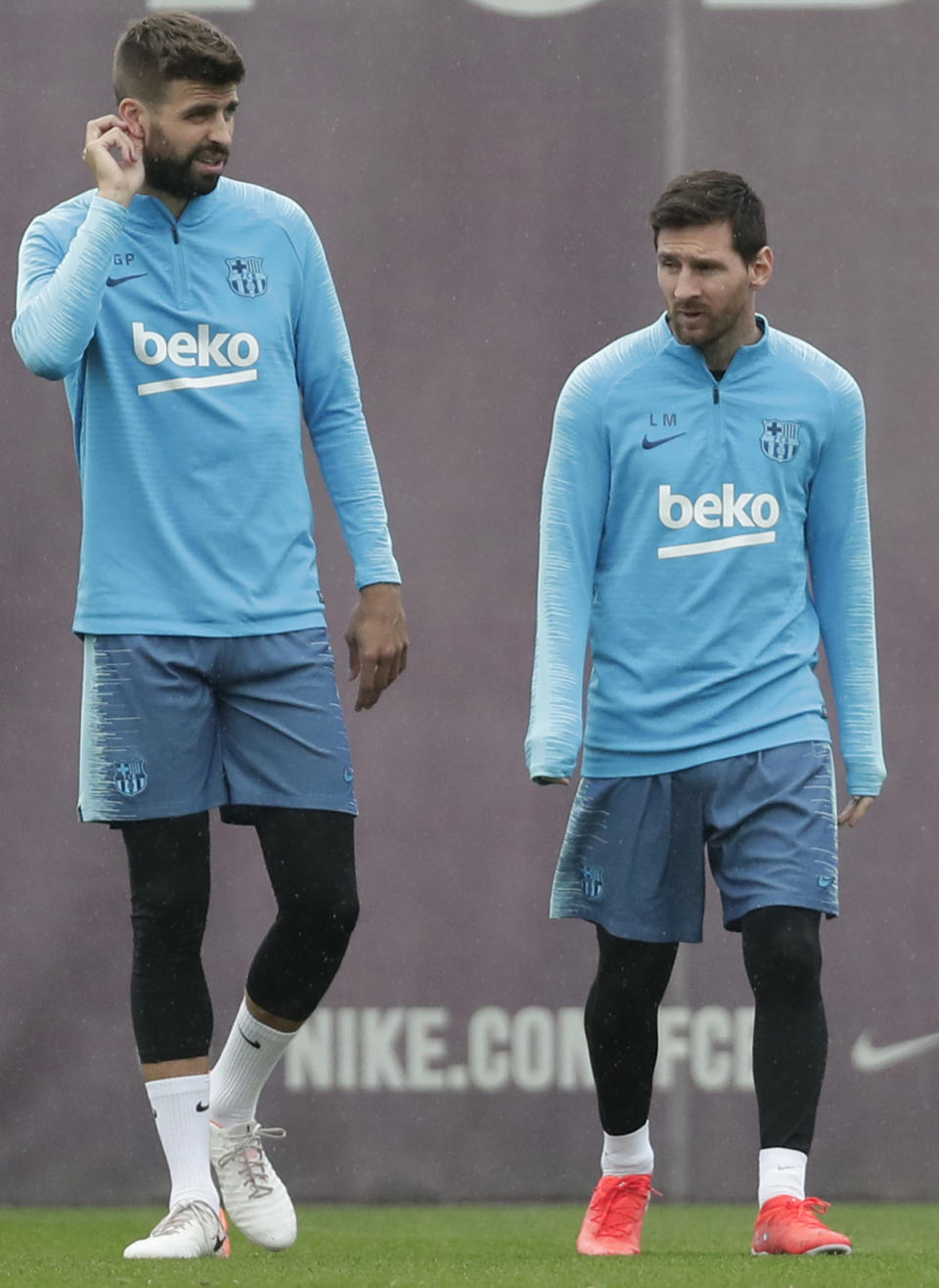 FC Barcelona's Lionel Messi, right, and Gerard Pique take part in a training session at the Sports Center FC Barcelona Joan Gamper in Sant Joan Despi, Spain, Friday, May 24, 2019. FC Barcelona will play against Valencia in the Spanish Copa del Rey soccer match final on Saturday. (AP Photo/Manu Fernandez)