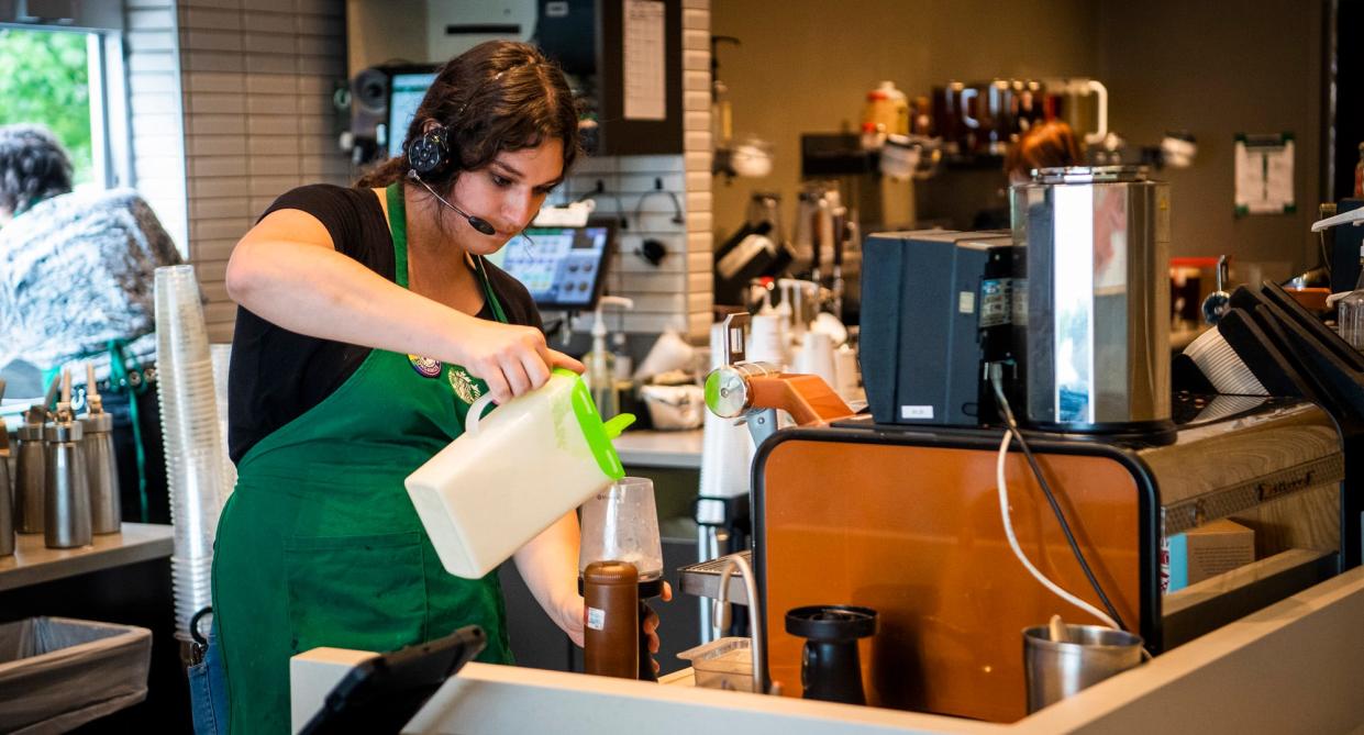 Stefanie Sharp makes a drink while working at Starbucks on Wednesday, June 29, 2023. 