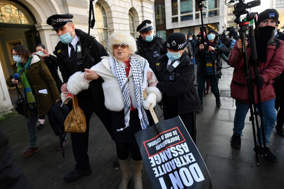 Police arrest a supporter of Wikileaks founder Julian Assange outside Westminster Magistrates court in London as he appears for a bail hearing on January 6, 2021. (Photo by JUSTIN TALLIS / AFP) (Photo by JUSTIN TALLIS/AFP via Getty Images)