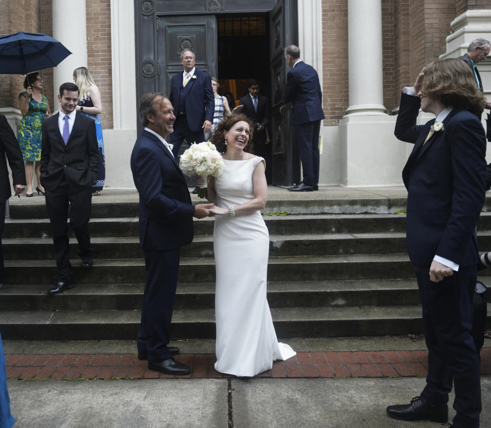 Associated Press staff photographer Gerald Herbert and Lucy Sikes smile after being wed at Mater Dolorosa Catholic Church ahead of Tropical Storm Barry in New Orleans, Friday, July 12, 2019. Originally scheduled for Saturday, the couple moved the nuptials up a day to avoid the arrival of Barry. (Max Becherer/The Advocate via AP)