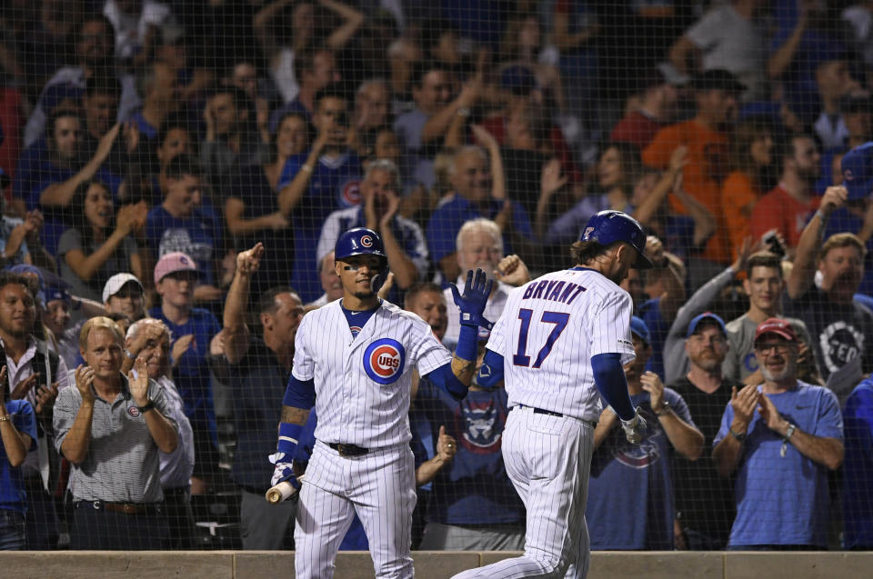 Chicago Cubs' Kris Bryant (17) celebrates with Javier Baez left, after hitting a two-run home run during the eighth inning of the team's baseball game against the San Francisco Giants on Wednesday, Aug 21, 2019, in Chicago. Chicago won 12-11. (AP Photo/Paul Beaty)