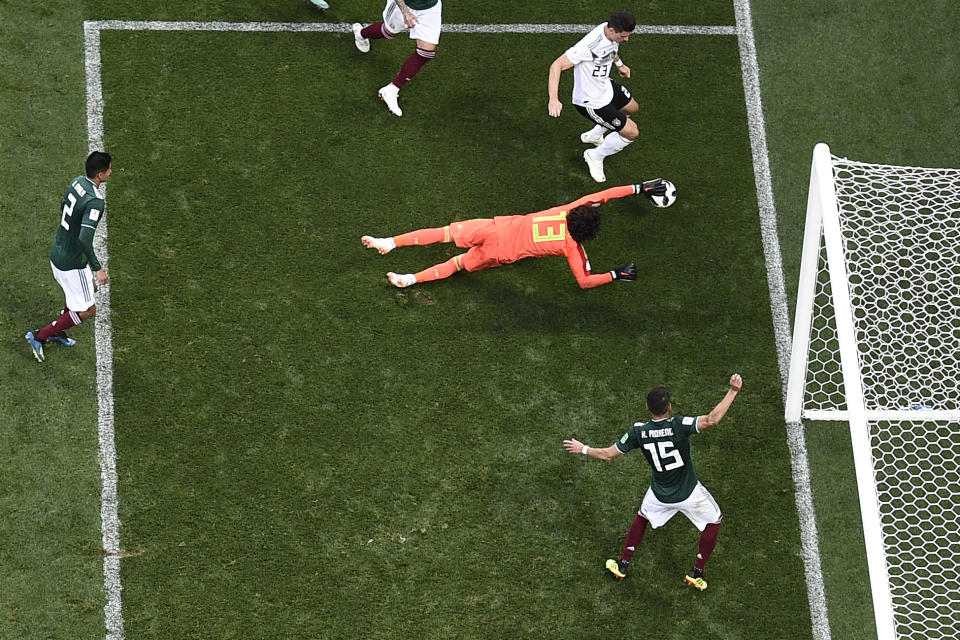 <p>Mexico’s goalkeeper Guillermo Ochoa (C) dives to save a shot by Germany’s forward Mario Gomez during the Russia 2018 World Cup Group F football match between Germany and Mexico at the Luzhniki Stadium in Moscow on June 17, 2018. (Photo by Mladen ANTONOV / AFP) </p>