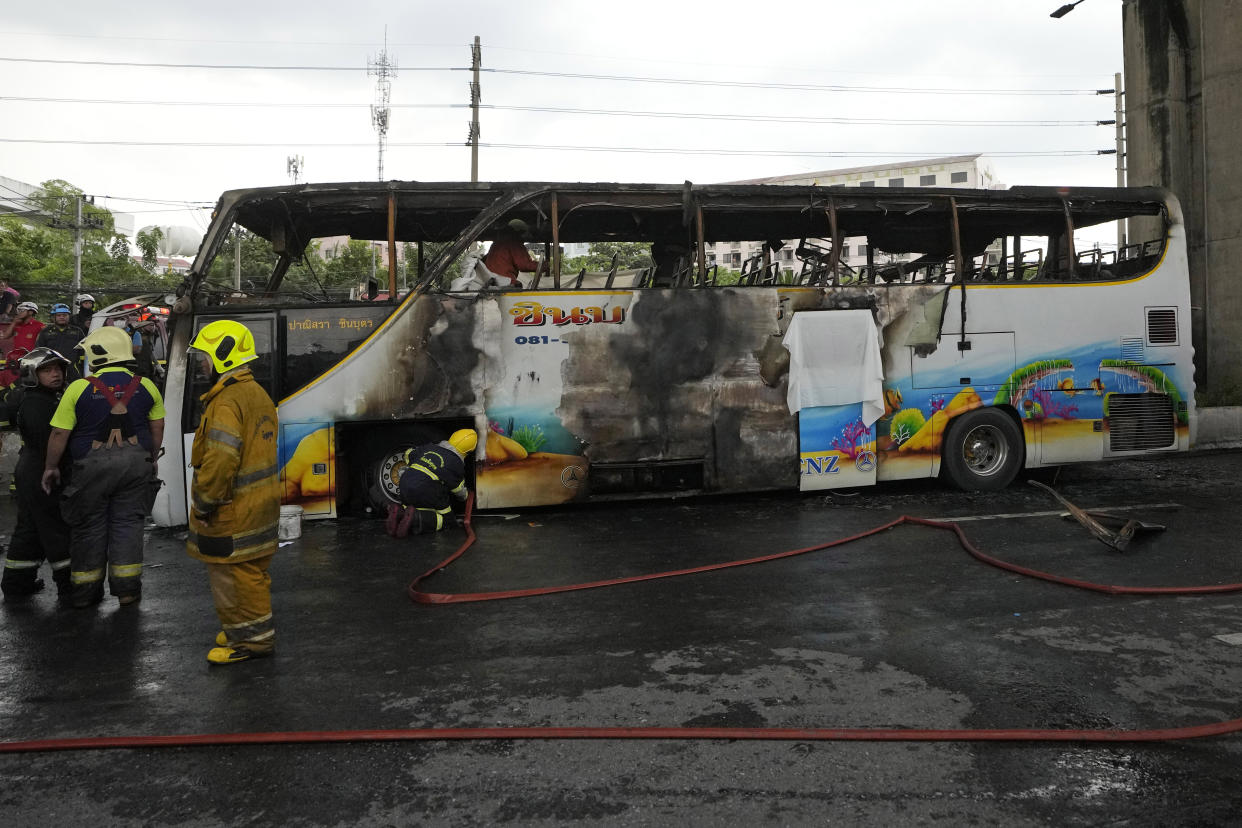 Rescuers work at the site of a bus that caught fire, carrying young students with their teachers, in suburban Bangkok, Tuesday, Oct. 1, 2024. (AP Photo/Sakchai Lalit)