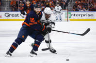 Los Angeles Kings center Anze Kopitar, right, and Edmonton Oilers left wing Zach Hyman chase the puck during the first period in Game 7 of a first-round series in the NHL hockey Stanley Cup playoffs Saturday, May 14, 2022, in Edmonton, Alberta. (Jeff McIntosh/The Canadian Press via AP)