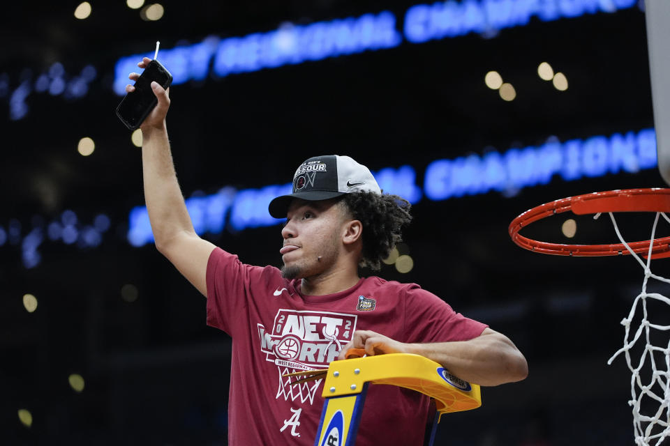 Alabama guard Mark Sears cuts down the net after a win over Clemson in Elite 8 college basketball game in the NCAA tournament Saturday, March 30, 2024, in Los Angeles. (AP Photo/Ryan Sun)