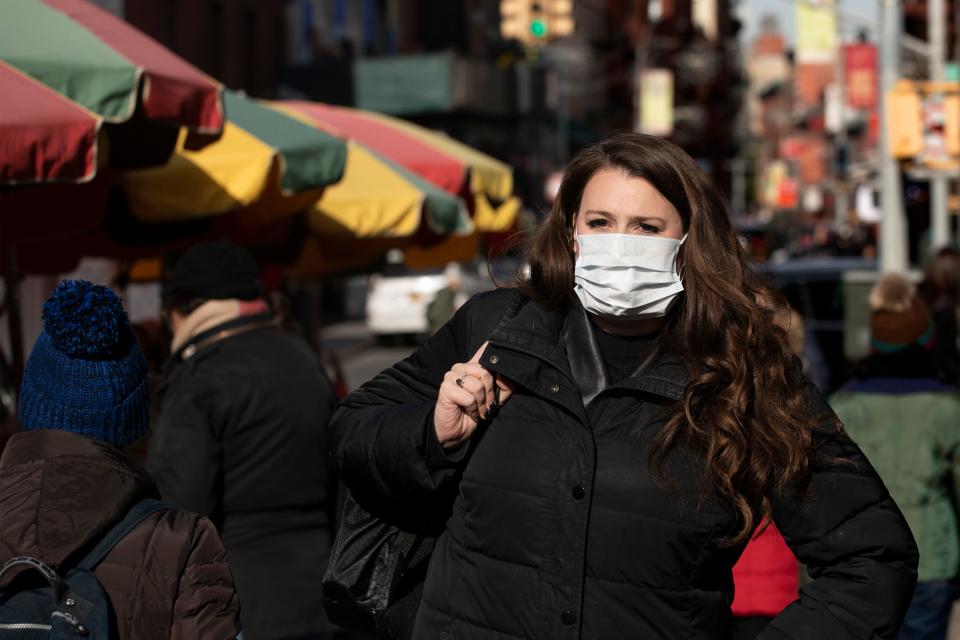 A woman, who declined to give her name, wears a mask out of concern for the coronavirus in New York. Health officials on Tuesday advised the public to stay aware and informed. (ASSOCIATED PRESS)