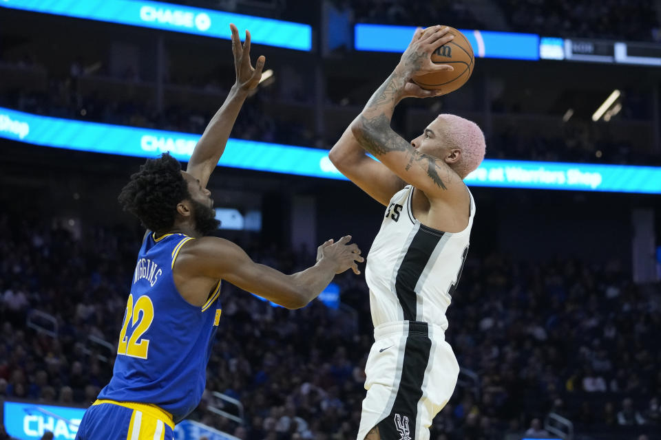 San Antonio Spurs forward Jeremy Sochan, right, shoots over Golden State Warriors forward Andrew Wiggins during the first half of an NBA basketball game in San Francisco, Monday, Nov. 14, 2022. (AP Photo/Godofredo A. Vásquez)