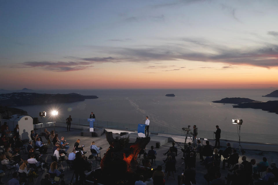 In this photo provided by the Prime Minister's Office, Greek Prime Minister Kyriakos Mitsotakis announces the opening of the tourist season during a news conference, on the Greek island of Santorini, Saturday, June 13, 2020. (Dimitris Papamitsos/Greek Prime Minister's Office via AP)