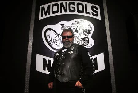 A member of the Mongols Motorcycle Club, known only as 'Crazy', poses for a photograph in their clubhouse located in western Sydney November 9, 2014. REUTERS/David Gray