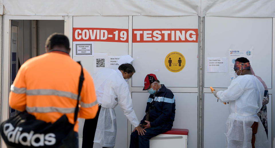 People are seen waiting to receive a Covid test in Lakemba on August 20, 2021.