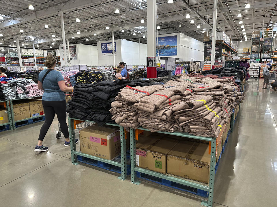 A shopper passes by a display of winter wear in a Costco warehouse on Wednesday, Oct. 4, 2023, in Sheridan, Colo. On Tuesday, the Commerce Department releases U.S. retail sales data for September. (AP Photo/David Zalubowski)