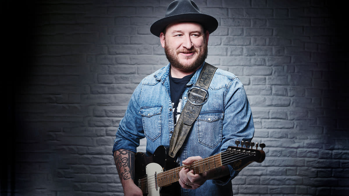  Josh Smith, standing with one of his Ibanez signature models. 