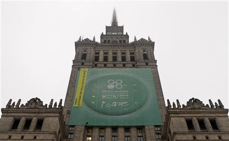 Greenpeace activists fix a banner on the Palace of Culture and Science demanding protection of the Arctic region and the release of the so-called "Arctic 30" group during the 19th conference of the United Nations Framework Convention on Climate Change (COP19) in Warsaw November 21, 2013. REUTERS/Kacper Pempel