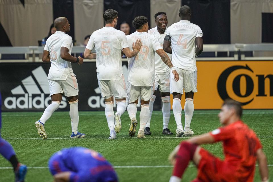 May 28, 2022; Atlanta, Georgia, USA; Columbus Crew players react with defender Jonathan Mensah (4) after his goal in the first minute against Atlanta United during the first half at Mercedes-Benz Stadium. Mandatory Credit: Dale Zanine-USA TODAY Sports