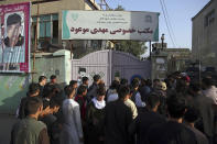 People gather at the site of a deadly suicide bombing that targeted a training class in a private building in the Shiite neighbourhood of Dasht-i Barcha, in western Kabul, Afghanistan, Wednesday, Aug. 15, 2018. The public Health Ministry said the casualty toll has risen to at least 48 dead and dozens wounded. (AP Photo/Rahmat Gul)