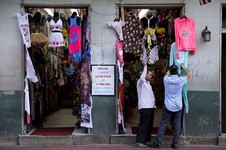 Business owners tend to their shop on Bourbon Street one day before the ten year anniversary of Hurricane Katrina in New Orleans, Louisiana, August 28, 2015. REUTERS/Jonathan Bachman