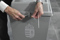 A ballot box is officially sealed by a member of the election committee at the start of the nationwide local elections in Budapest, Hungary, Sunday, Oct. 13, 2019. (Szilard Koszticsak/MTI via AP)