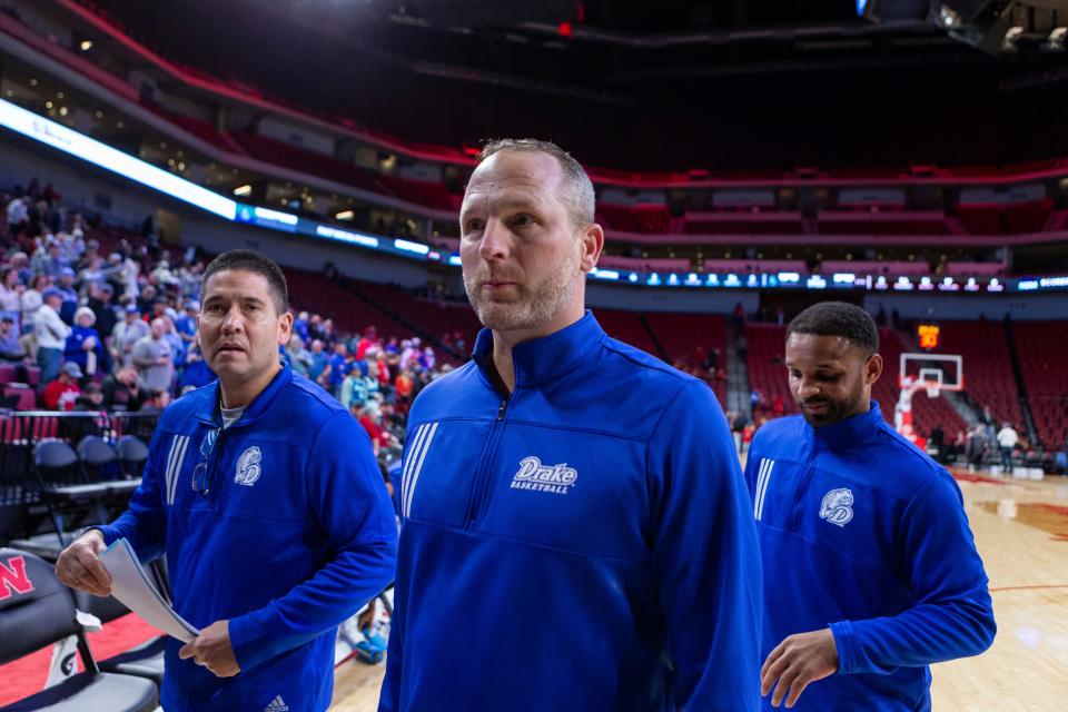 Drake coach Darian DeVries, center, walks off the court after his team defeated Mississippi State on Tuesday in Lincoln, Neb.