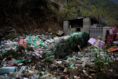 Recycled beer bottles are seen outside Cha's home in Lazimi village in Nujiang Lisu Autonomous Prefecture in Yunnan province, China, March 24, 2018. Picture taken March 24, 2018. REUTERS/Aly Song