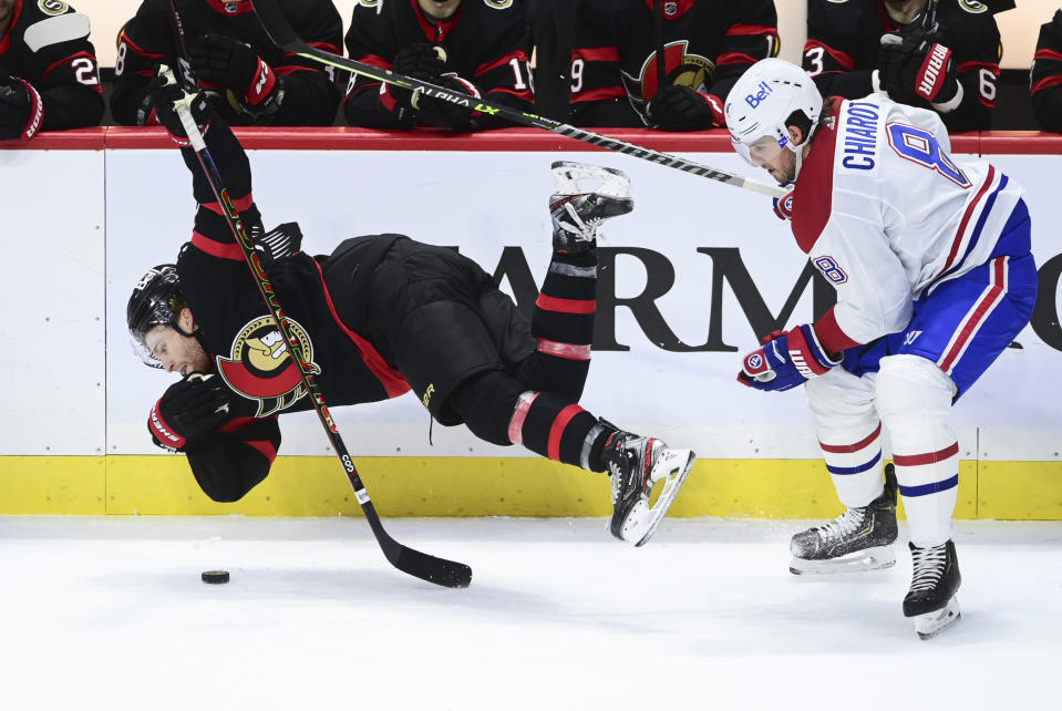 Ottawa Senators right wing Connor Brown (28) gets hit to the ice by Montreal Canadiens defenseman Ben Chiarot (8) during the third period of an NHL game in Ottawa, Ontario on Tuesday, Feb. 23, 2021. (Sean Kilpatrick/The Canadian Press via AP)