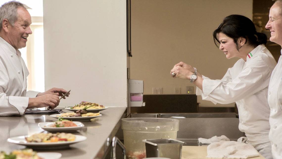 Chef Wolfgang Puck works with contestant Carla Pellegrino in 2012 on “Top Chef: Seattle,” season 10.