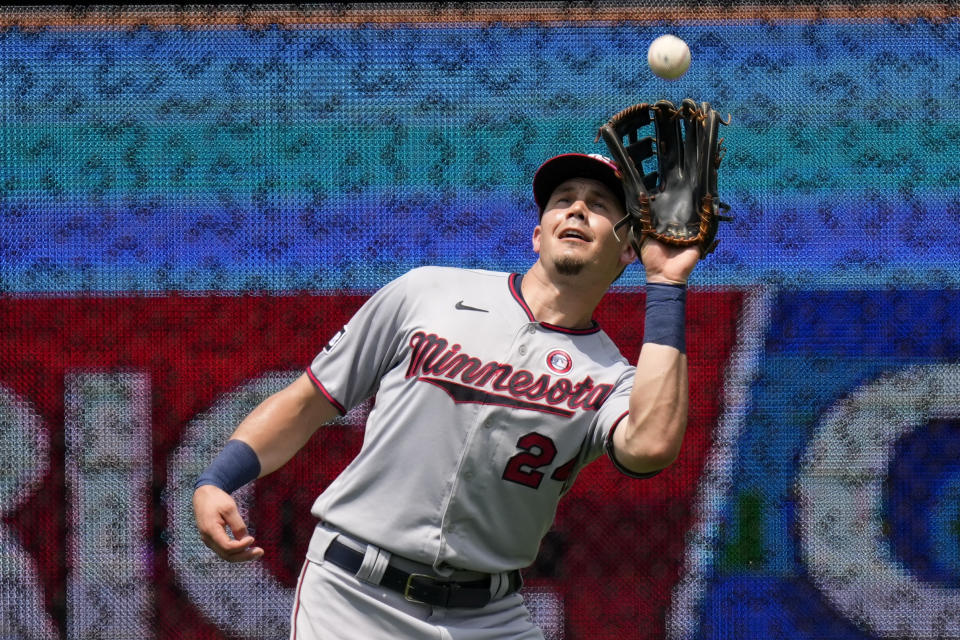 Minnesota Twins left fielder Trevor Larnach catches a fly ball for the out on Kansas City Royals' Ryan O'Hearn during the fourth inning of a baseball game Sunday, July 4, 2021, in Kansas City, Mo. (AP Photo/Charlie Riedel)