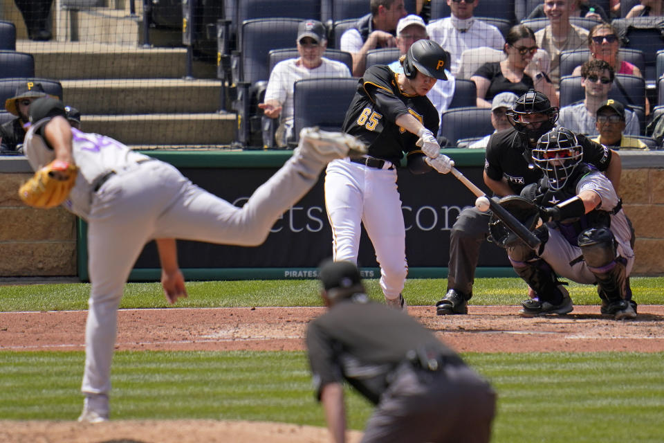 Pittsburgh Pirates' Jack Suwinski (65) hits a three-run home run off Colorado Rockies relief pitcher Carlos Estevez (54) during the sixth inning of a baseball game in Pittsburgh, Wednesday, May 25, 2022. The Pirates won 10-5. (AP Photo/Gene J. Puskar)