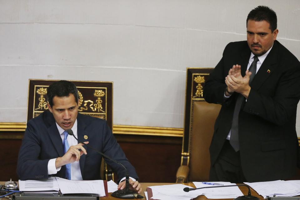 Venezuelan opposition leader and self-proclaimed interim president of Venezuela Juan Guaido, left, speaks as National Assembly Second Vice President Stalin González applauds him during the body's weekly session in Caracas, Venezuela, Tuesday, Sept. 17, 2019. Venezuela’s opposition-led congress has again thrown its support behind Guaidó, saying he’ll serve as the crisis-wracked nation’s interim president until they’ve ended Nicolás Maduro’s grip on power. (AP Photo/Ariana Cubillos)