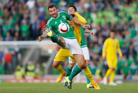 Football - Northern Ireland v Romania - UEFA Euro 2016 Qualifying Group F - Windsor Park, Belfast, Northern Ireland - 13/6/15 Northern Ireland's Gareth McAuley in action with Romania's Florin Andone Action Images via Reuters / Peter Cziborra Livepic