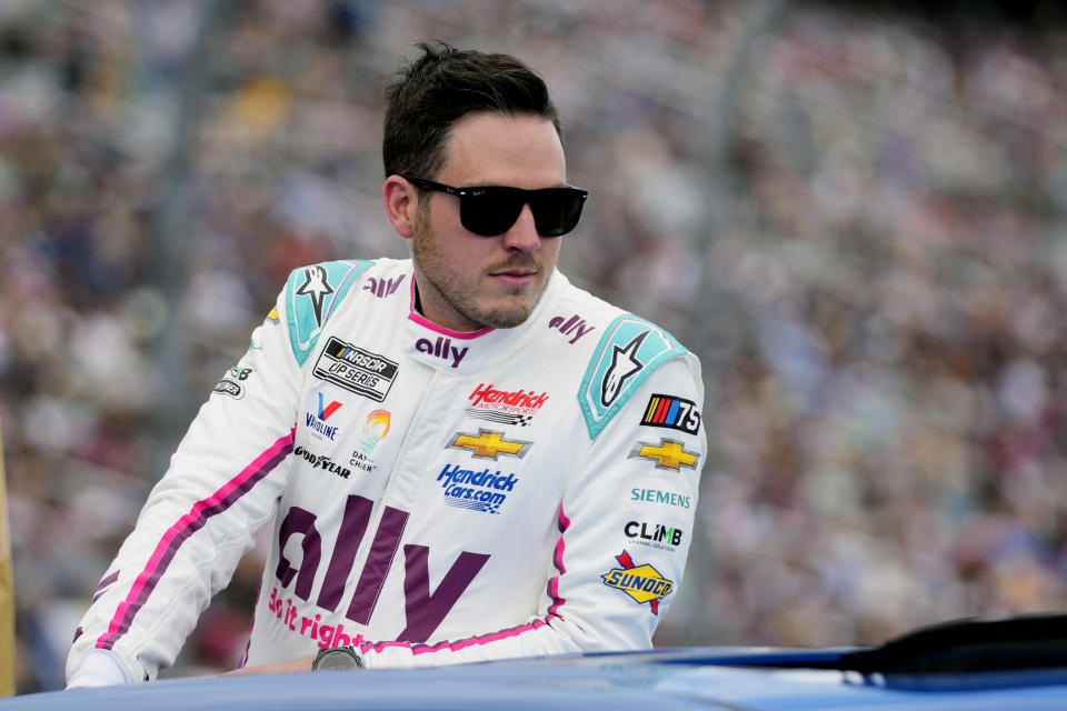 FILE - Alex Bowman looks on during driver introductions before the NASCAR Daytona 500 auto race at Daytona International Speedway, Sunday, Feb. 19, 2023, in Daytona Beach, Fla. Bowman has been cleared to return to racing this weekend for the Coca-Cola 600 at Charlotte Motor Speedway after missing four events with a fractured vertebra. (AP Photo/John Raoux)