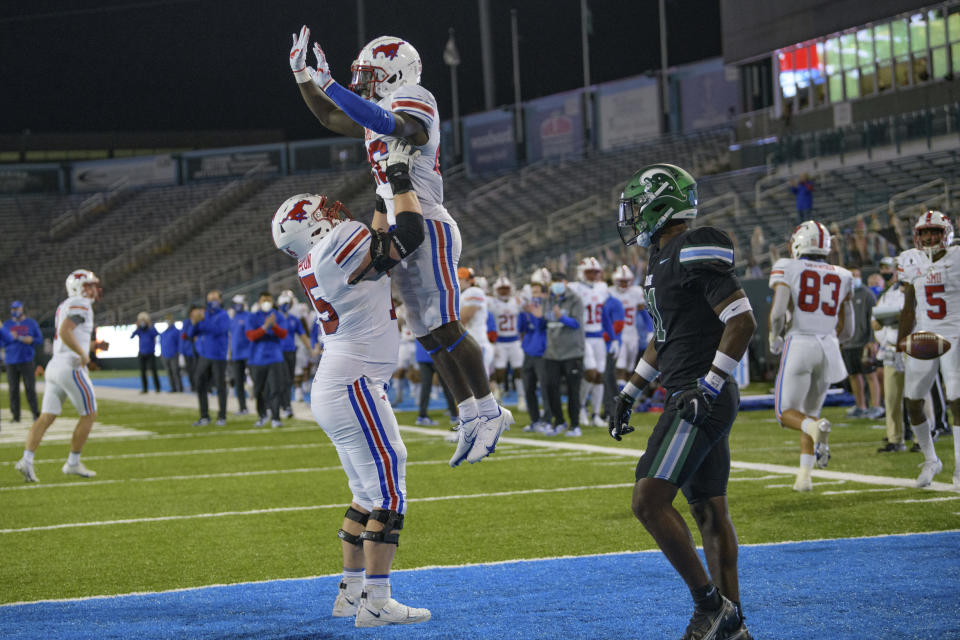 SMU running back Ulysses Bentley IV (26) celebrates a touchdown with offensive lineman Hayden Howerton (75) during the second half an NCAA college football game against Tulane in New Orleans, Friday, Oct. 16, 2020. (AP Photo/Matthew Hinton)