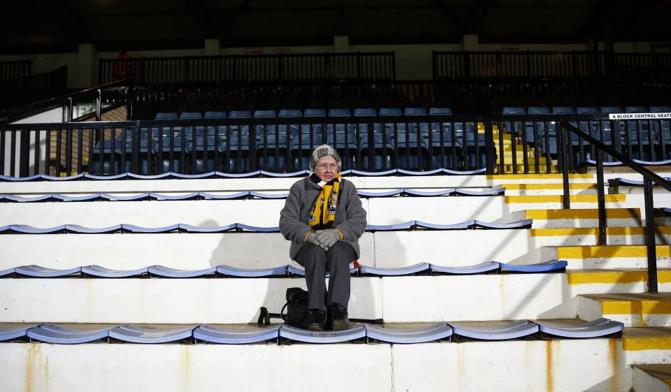 A Cambridge United fan sits alone on her seat before their English FA Cup 4th round soccer match against Manchester United at The Abbey Stadium in Cambridge, eastern England January 23, 2015. REUTERS/Andrew Winning (BRITAIN - Tags: SPORT SOCCER)