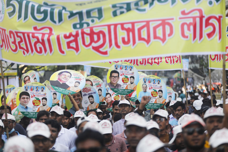 Bangladesh's ruling Awami League supporters shout slogans as they gather for a peace rally in Dhaka, Bangladesh, Friday, July 28, 2023. Thousands of supporters of Bangladesh's governing and opposition parties have held separate rallies over who should oversee the next general election, expected to be held early next year. Despite huge crowds, both rallies were peaceful, with a large security presence. (AP Photo/Mahmud Hossain Opu)