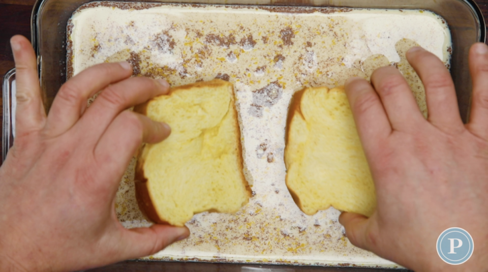 Dipping Bread Slices in Custard for French Toast<p>Parade</p>