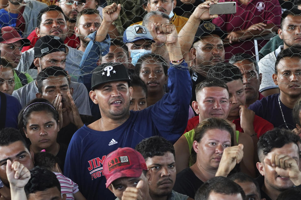 Migrants, many from Central America and Venezuela, attend an assembly while sheltering in a sports complex in Huixtla, Chiapas state, Mexico, Wednesday, June 8, 2022. The group left Tapachula on Monday, tired of waiting for their status in a region with little work and far from their ultimate goal of reaching the United States. (AP Photo/Marco Ugarte)