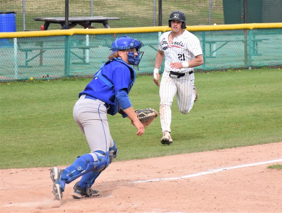 Chance Checca (21) is pictured scoring a run for Herkimer College May 7. Checca doubled, tripled and drove in five runs for the Albany Dutchmen in a PGCBL game Sunday.