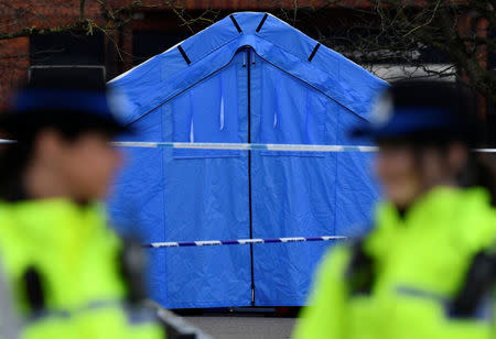 Police officers stand guard in front of a forensics tent in a cordoned off area in the centre of Salisbury, Britain, March 7, 2018. REUTERS/Toby Melville