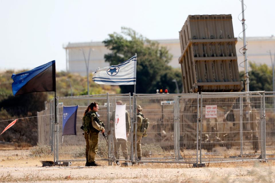 Israeli soldiers near an Iron Dome missile defense system in the southern city of Ashkelon on May 15, 2021. / Credit: JACK GUEZ/AFP via Getty Images