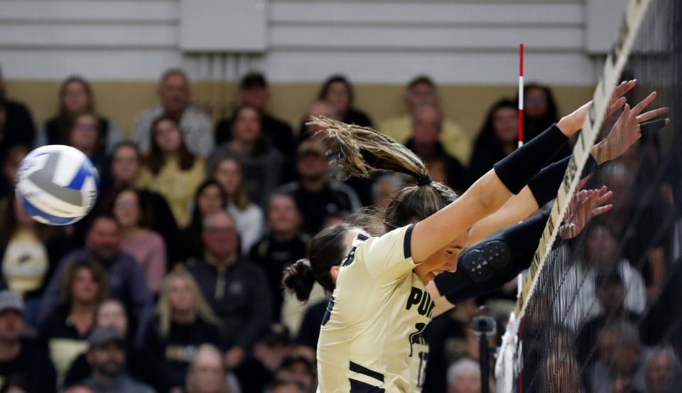 Purdue middle blocker Lizzie Carr (15) and Purdue outside hitter Eva Hudson (17) go for a block in Thursday's first-round NCAA Tournament win.