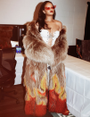 <p>Wearing a flame-dyed, floor-length, fur coat, with a white, lace-up corset. Posted on Instagram.</p>