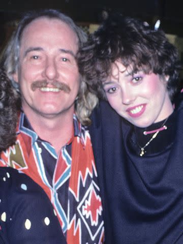 <p>Allan Tannenbaum/Getty</p> John Phillips and Mackenzie Phillips backstage at Paul Colby's 'The Other End' on March 3, 1982.