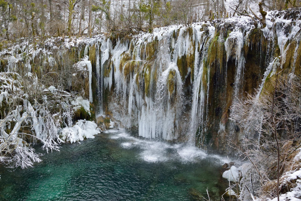 <p>Waterfalls that are frozen in time, cascading turquoise lakes and trees sprinkled with snow. Plitvice National Park is one of Croatia’s main tourist attractions – but you’ll get it almost to yourselves in winter, when there are fewer tourists around. It’s about 140km from Zagreb, which takes roughly 2 hours 30 minutes to fly to from the UK.<em> [Photo: Getty]</em> </p>