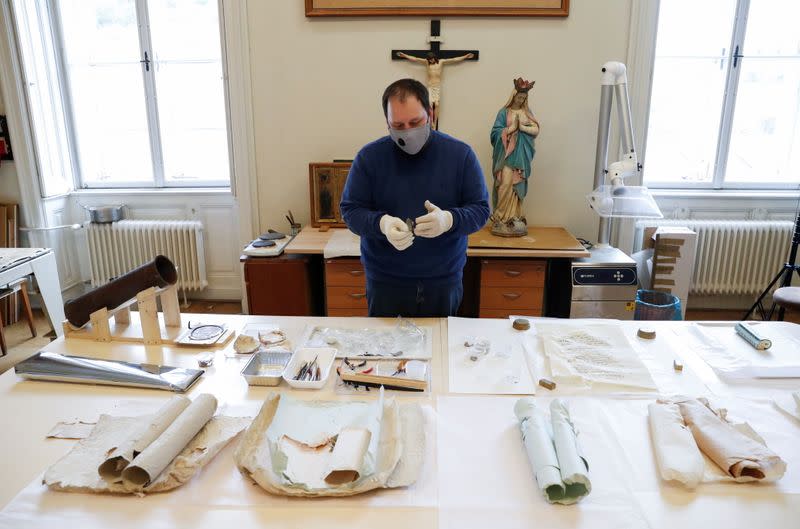 Torok, director of the Cathedral's Treasury checks items of the time capsule found in the Esztergom Cathedral, in Esztergom