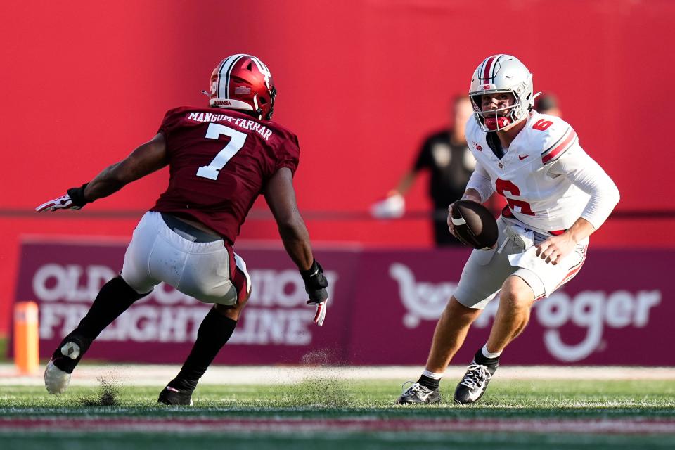 Sep 2, 2023; Bloomington, Indiana, USA; Ohio State Buckeyes quarterback Kyle McCord (6) scrambles away from Indiana Hoosiers linebacker Jacob Mangum-Farrar (7) during the NCAA football game at Indiana University Memorial Stadium. Ohio State won 23-3.