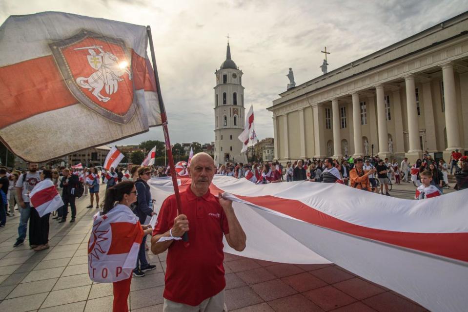 Protesters hold a huge white-red-white flag during the Belarusians' march on the third anniversary of the 2020 presidential election in Belarus, Vilnius, Lithuania, on Aug. 9, 2023. (Yerchak Yauhen/SOPA Images/LightRocket via Getty Images)