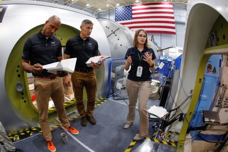 NASA commercial crew astronauts Michael Hopkins and Victor Glover run through a training session at a replica International Space Station (ISS) at the Johnson Space Center in Houston, Texas