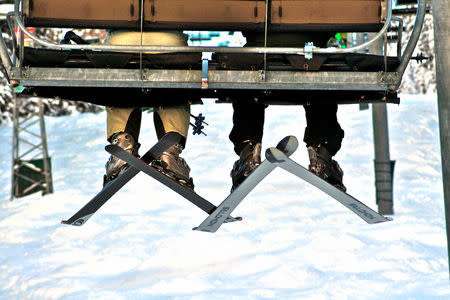 FILE PHOTO: People ride a ski lift at Taos Ski Valley, New Mexico, in December 2007. REUTERS/Christa Cameron/File Photo