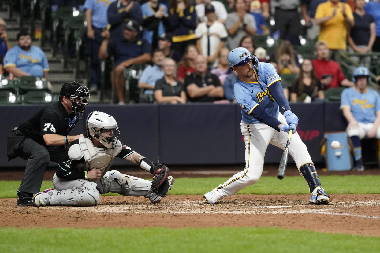 Milwaukee Brewers' Rhys Hoskins hits a two-run single during the eighth inning of a baseball game against the Arizona Diamondbacks, Sunday, Sept. 22, 2024, in Milwaukee. (AP Photo/Aaron Gash)