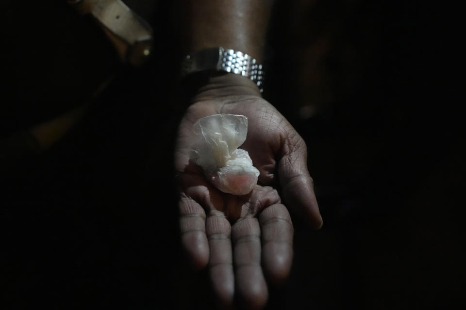 A Sri Lankan police officer shows a parcel of narcotics recovered from a suspected drug offender during a search operation in Colombo, Sri Lanka, Thursday, Jan. 18, 2024. (AP Photo/Eranga Jayawardena)