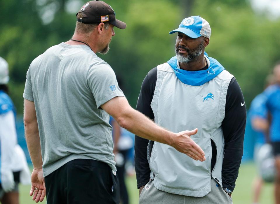 Detroit Lions head coach Dan Campbell, left, talks to general manager Brad Holmes during minicamp at Detroit Lions Headquarters and Training Facility in Allen Park on Tuesday, June 6, 2023.